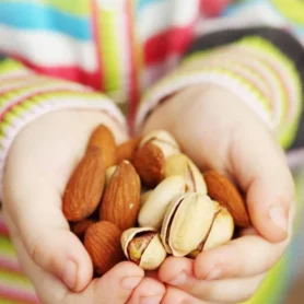 depositphotos_239755834-stock-photo-nuts-almonds-pistachios-children-hands